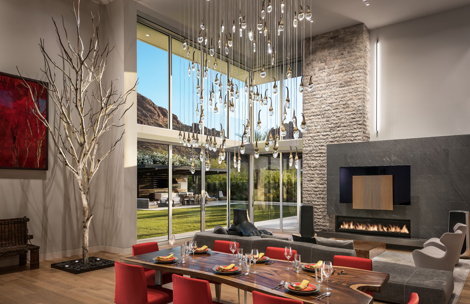 Dining area and great room in daylight, whole-home audio and shading integrated out of sight