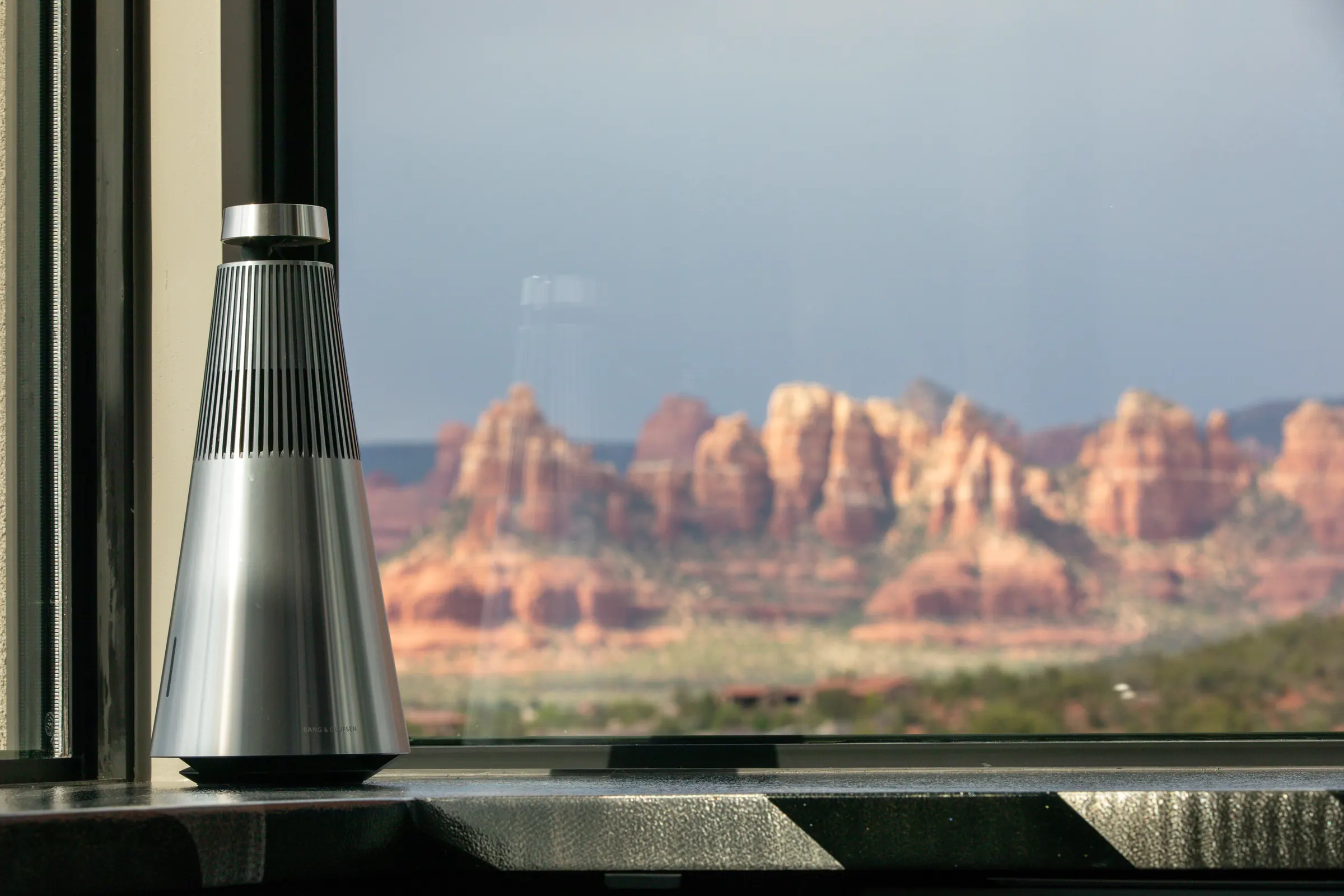 Bang & Olufsen Beosound 2 speaker on a windowsill framing Sedona red rock views — a Watt Integration whole-home audio project