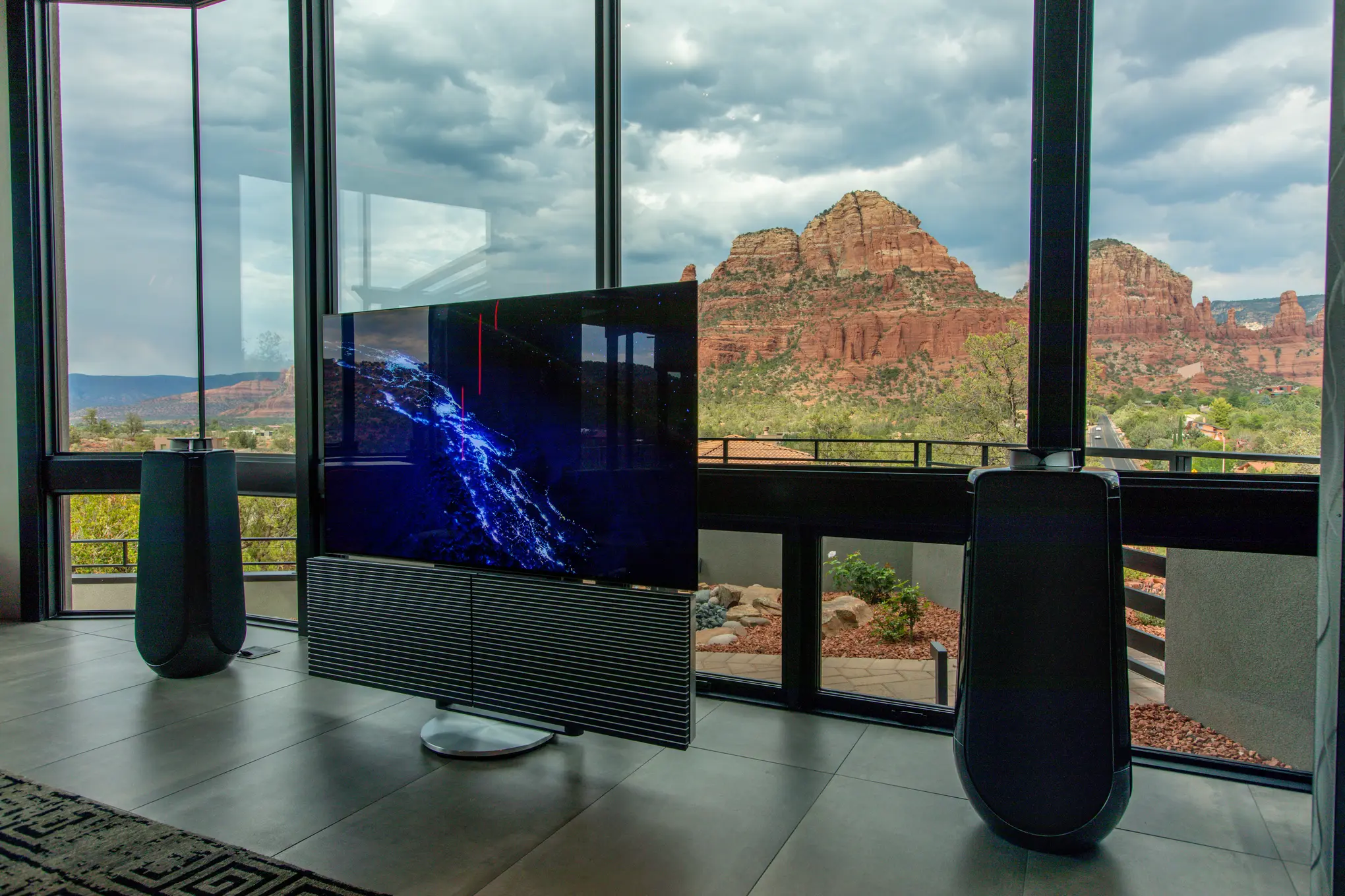 Bang & Olufsen Beovision Harmony and Beolab 50 speakers seen from the side, Sedona red rocks through the corner glass — Watt Integration project home