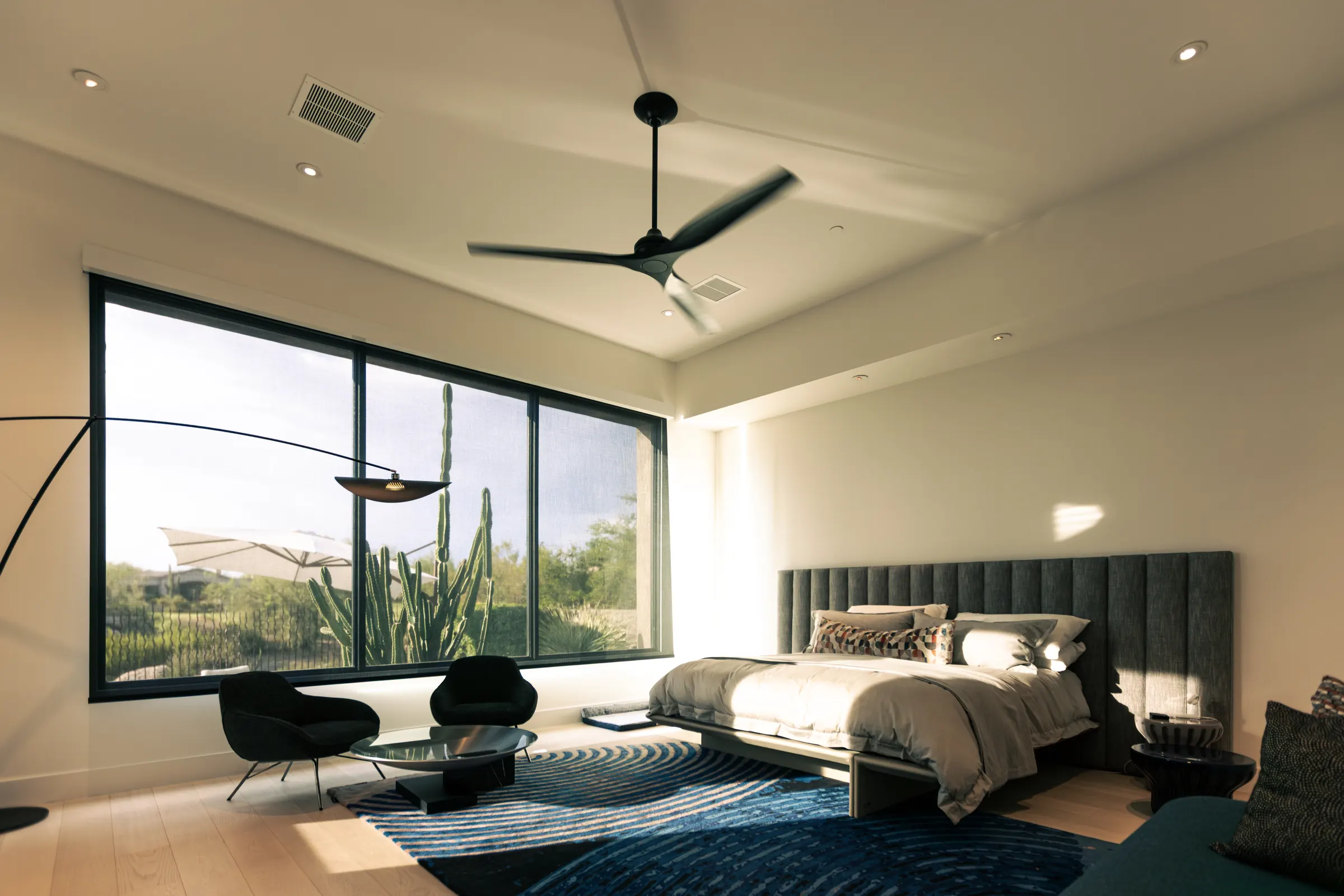 The same bedroom window with Lutron motorized screen shades lowered, sun filtered