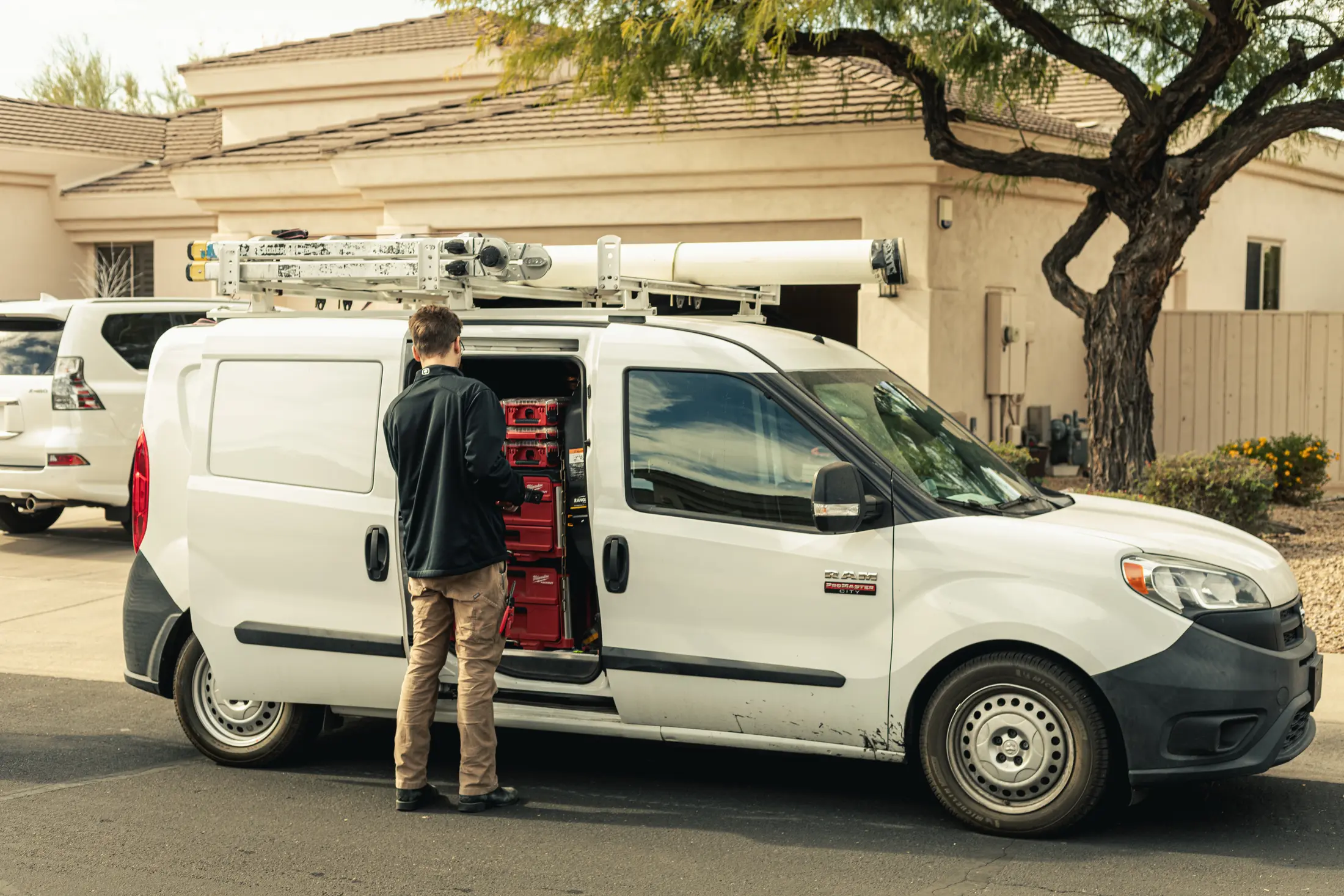 Watt Integration technician at the service van's organized parts cases, on a Scottsdale service call