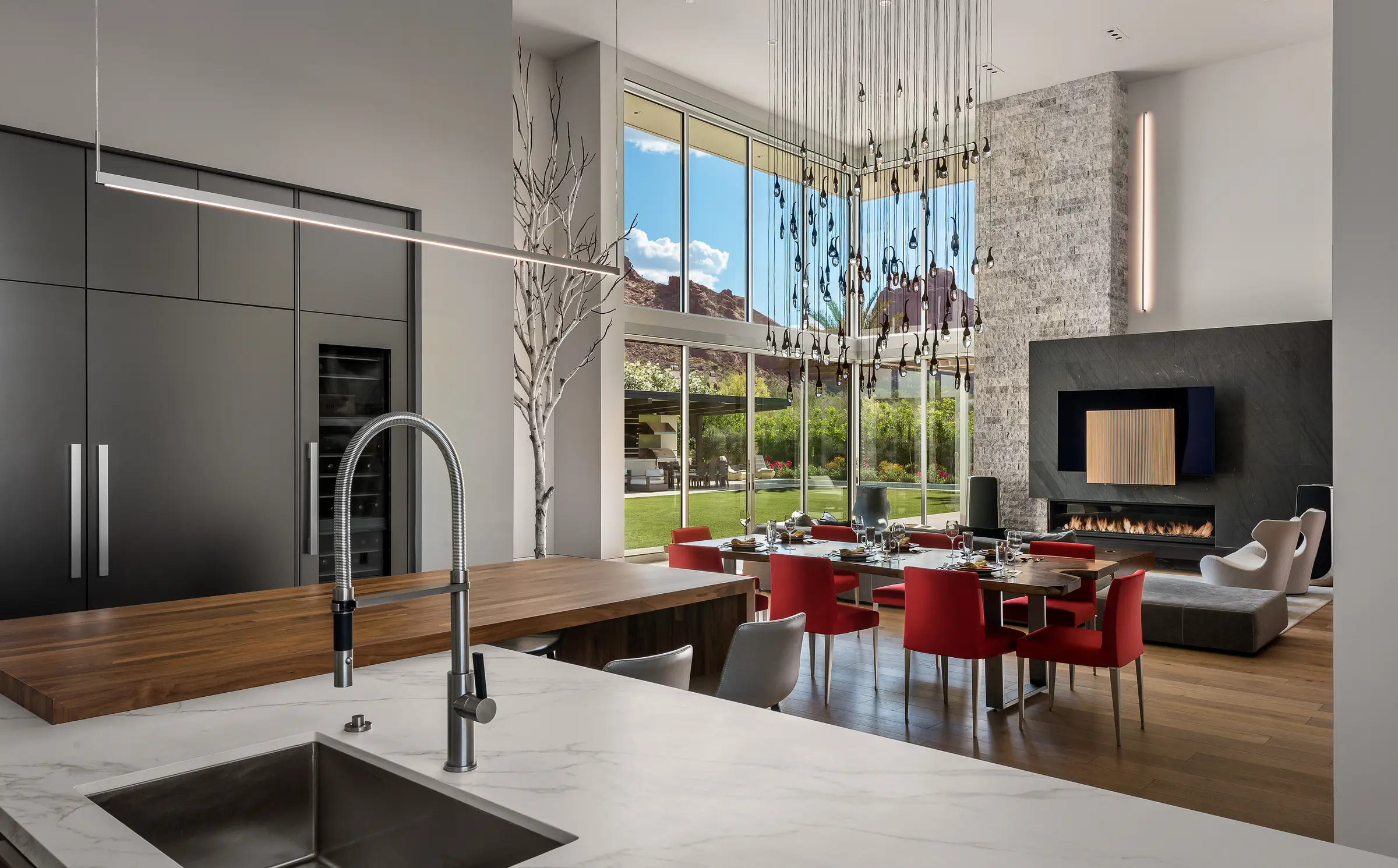 Open-plan kitchen and dining area of a Scottsdale project home with a media wall